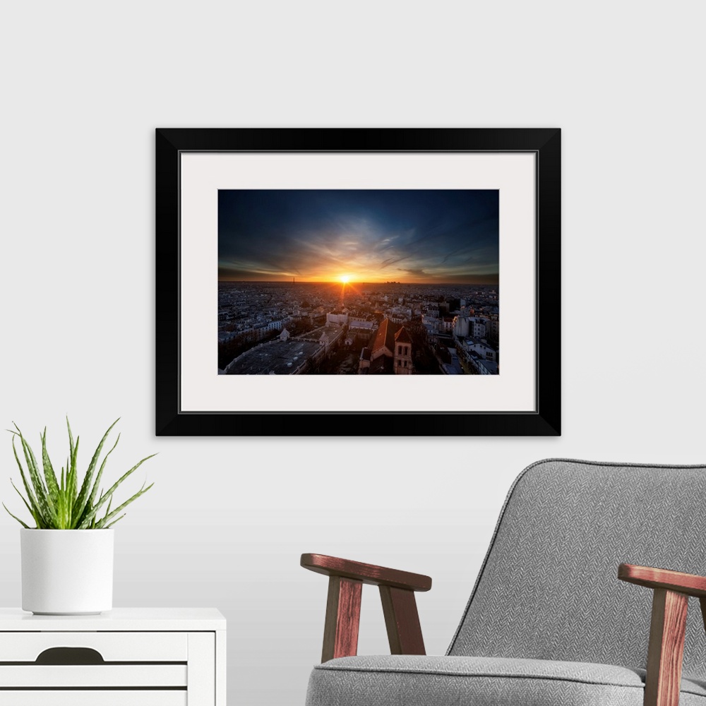 A modern room featuring A photograph of Paris at Sunset.