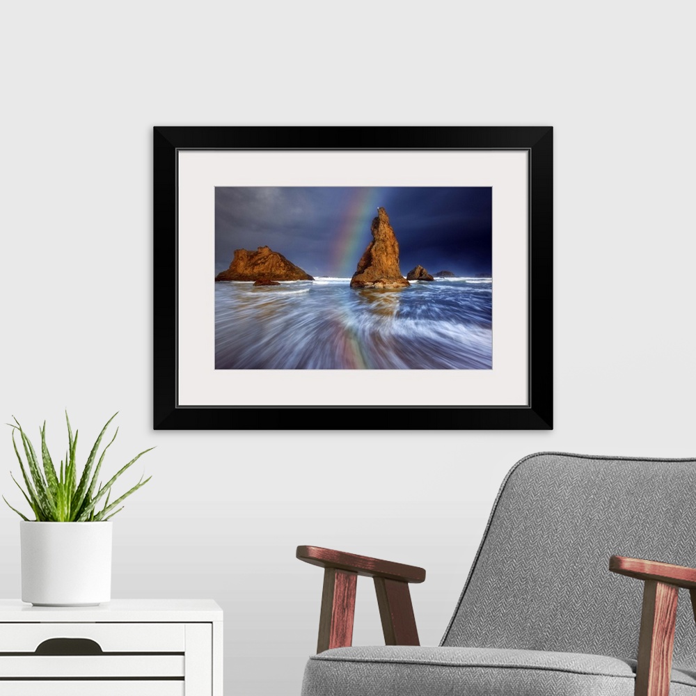 A modern room featuring A rainbow over sea stacks in the ocean.