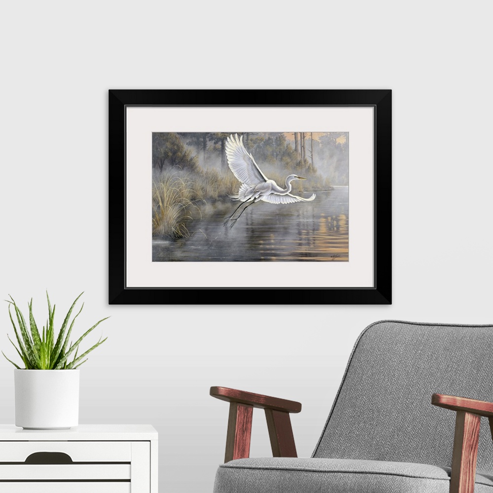 A modern room featuring Great white egret flying over a pond at sunrise.