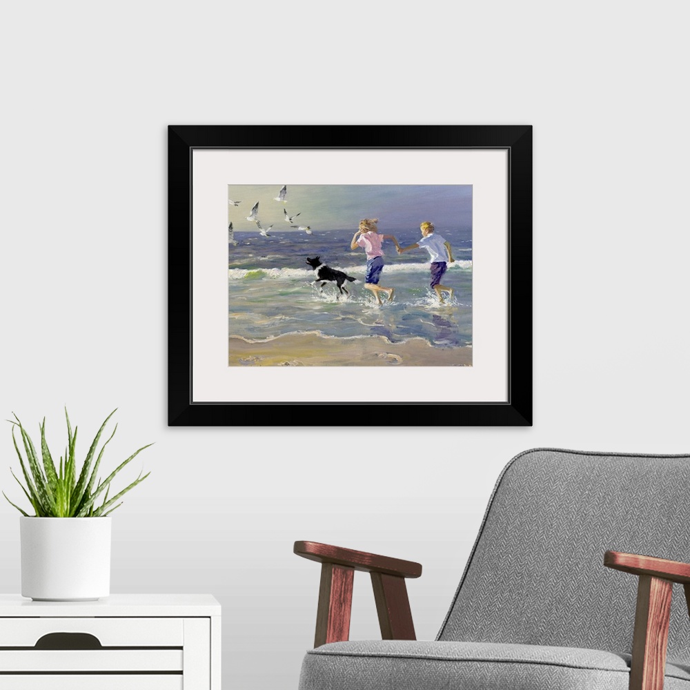 A modern room featuring Painting of two children holding hands running on the beach as a dog chases birds in front of the...