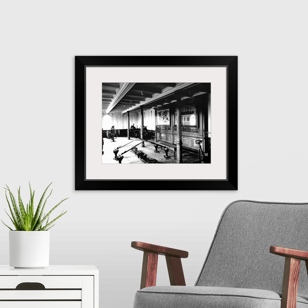 A modern room featuring Landscape, vintage photograph from 1912 of the exercise room on the Titanic, including a rowing m...