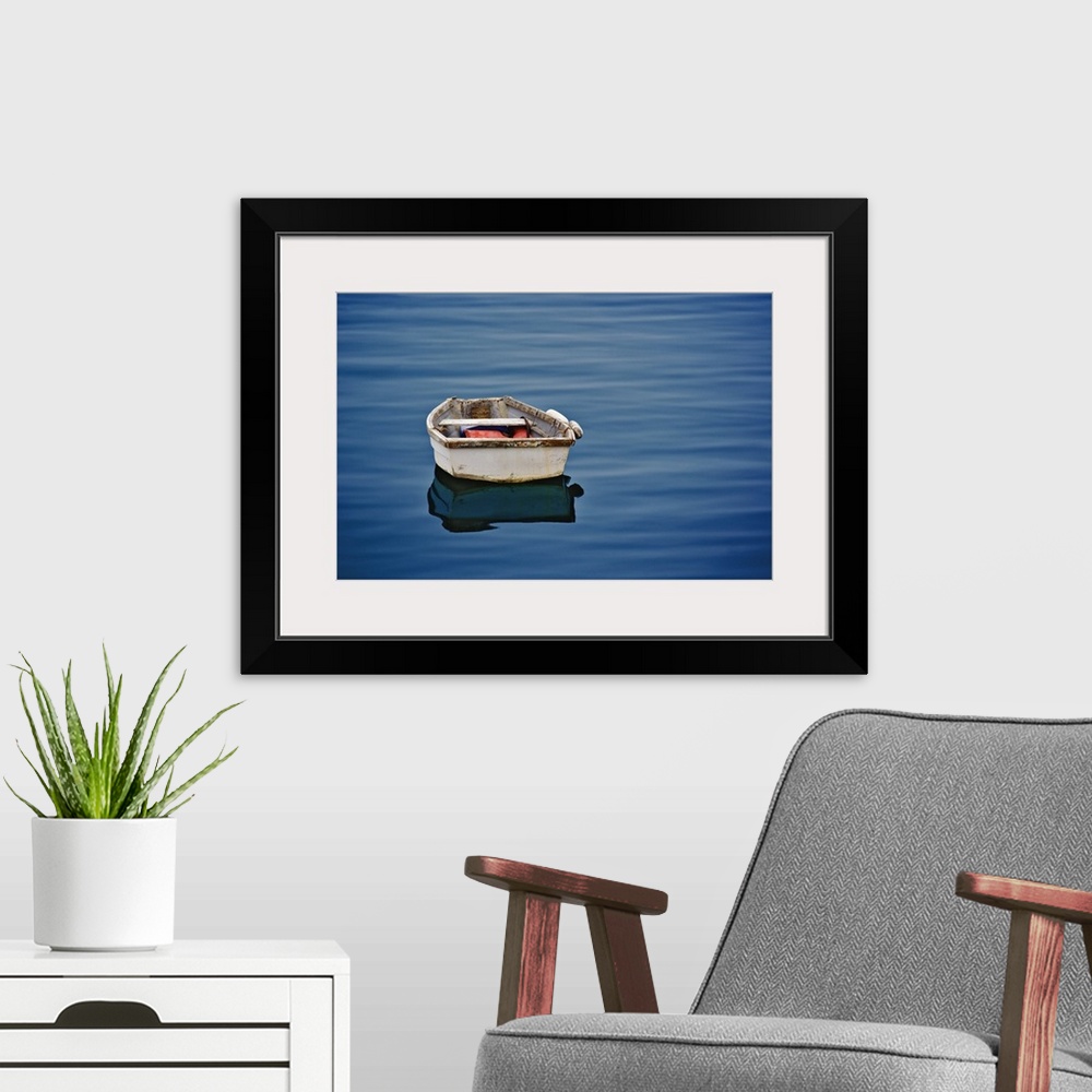 A modern room featuring Single small boat floating on ocean, Maine