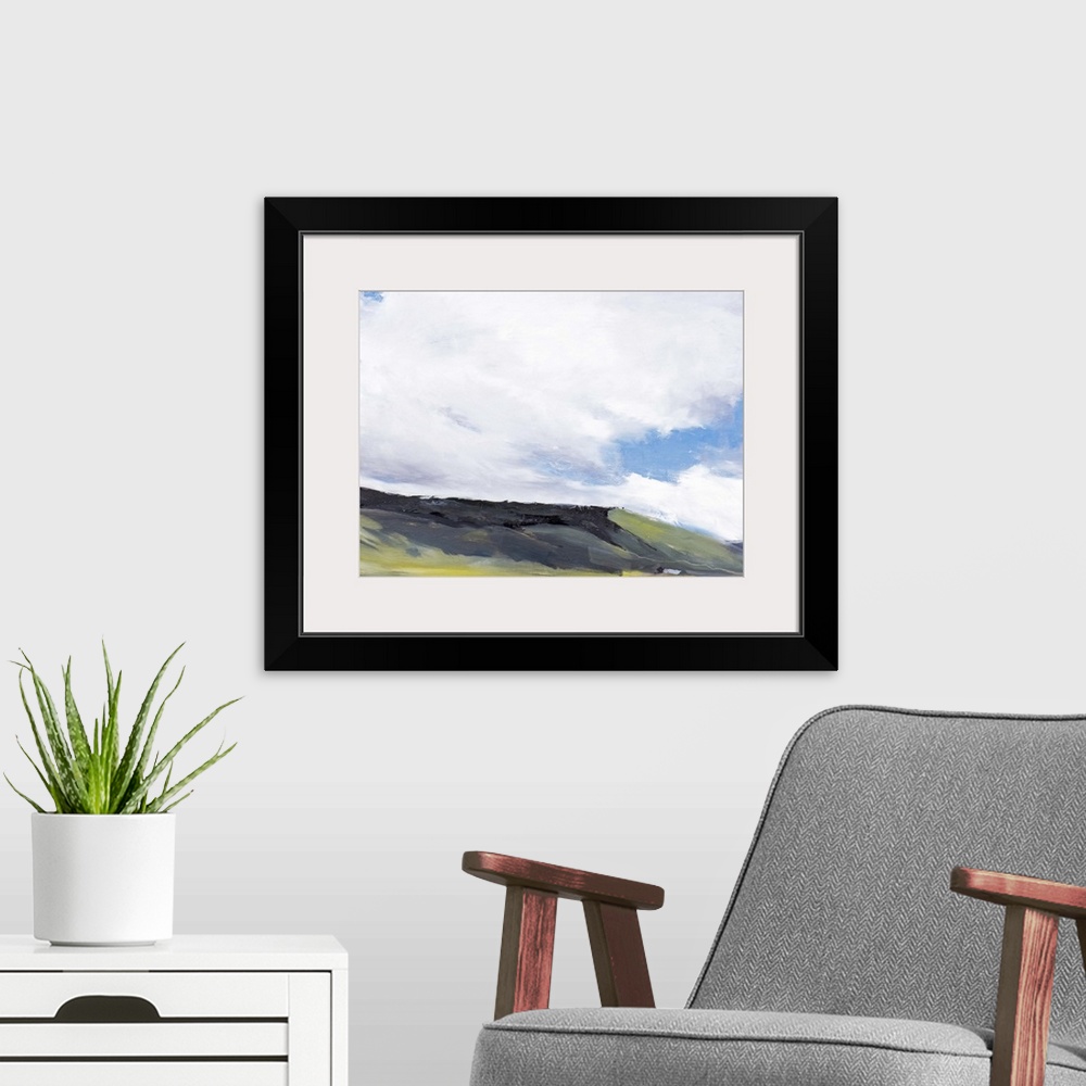 A modern room featuring Contemporary painting of a hillside landscape under a sky with large clouds hanging overhead.