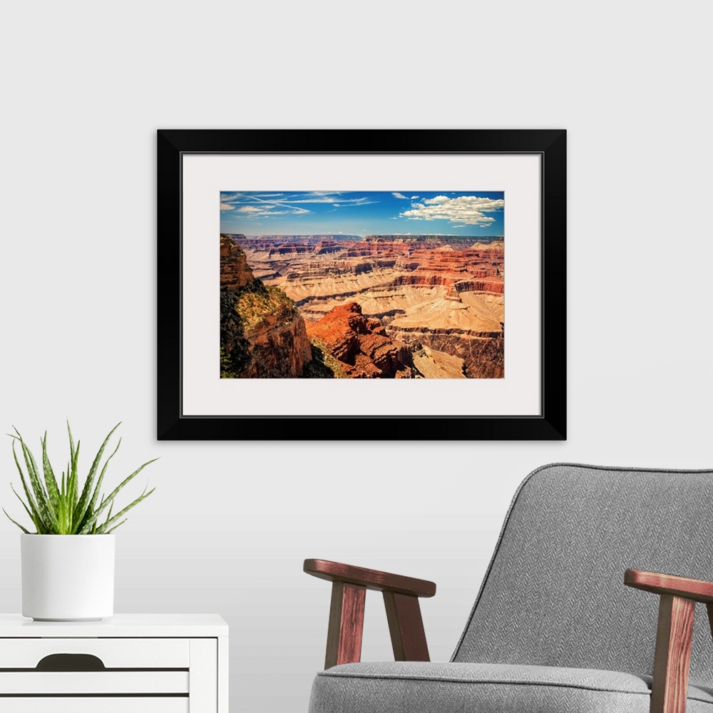 A modern room featuring Grand Canyon on a sunny day with blue sky.