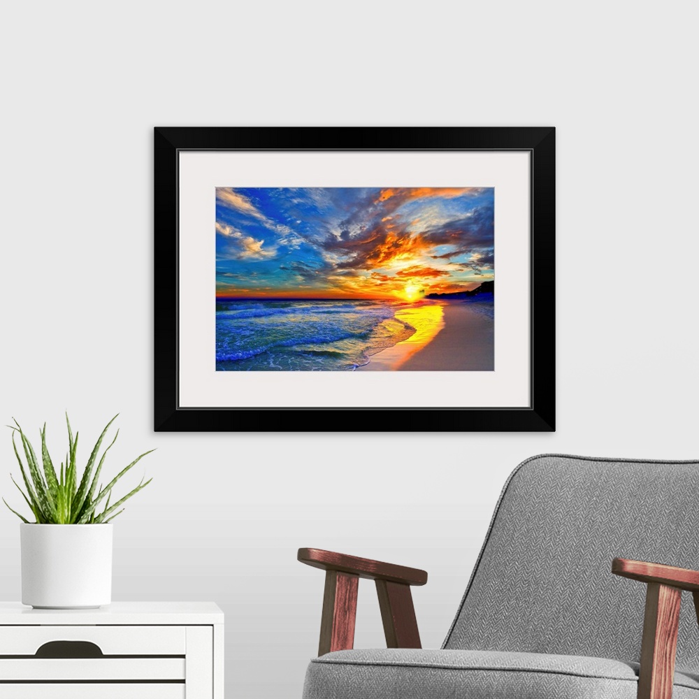 A modern room featuring An amazing sunset with red and blue sky and clouds. A blue seascape and beach below.