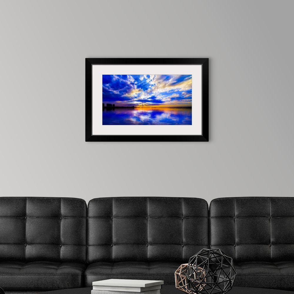 A modern room featuring The sunset reflected in this blue and white seascape during sunset.