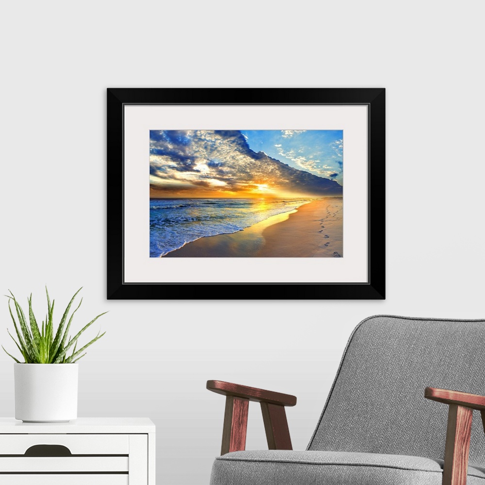 A modern room featuring Bright golden sunset casts light onto the beach and blue seascape below. Landscape taken on Navar...