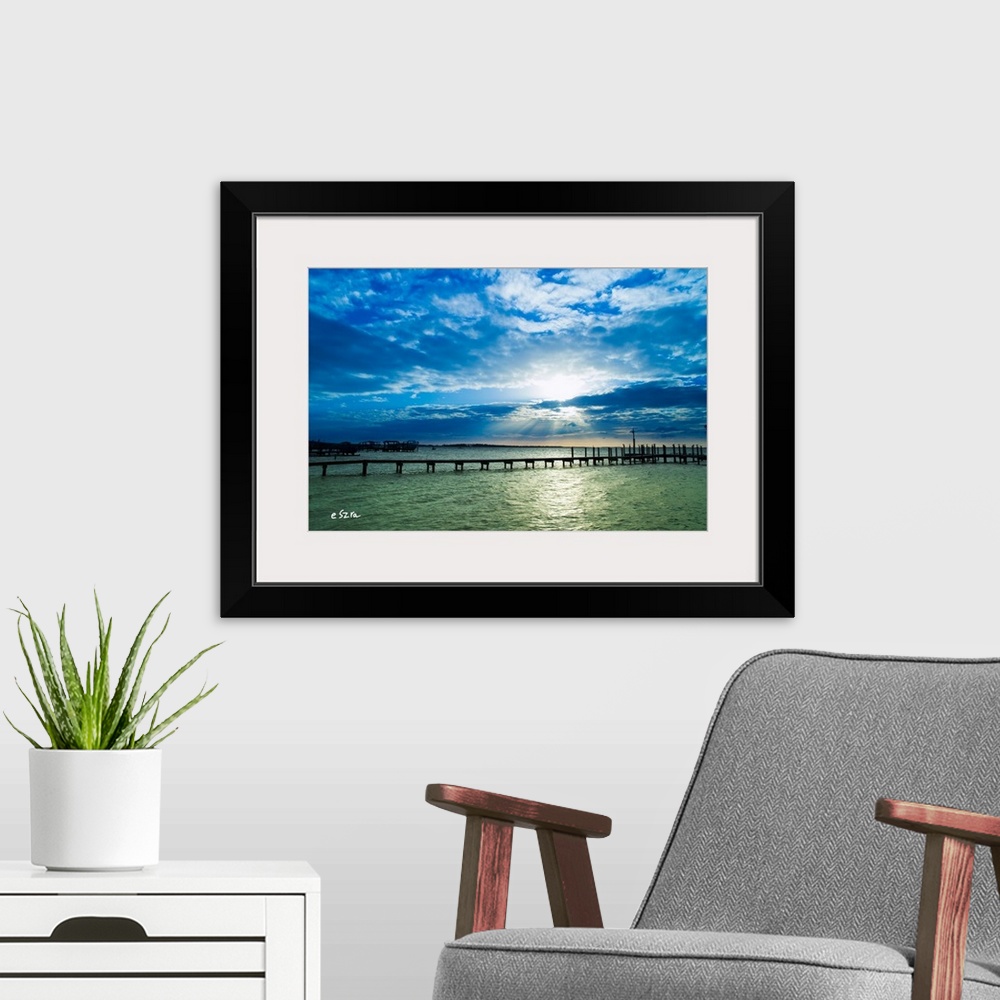 A modern room featuring A lonely pier on a shimmering sea in Pensacola, Florida.
