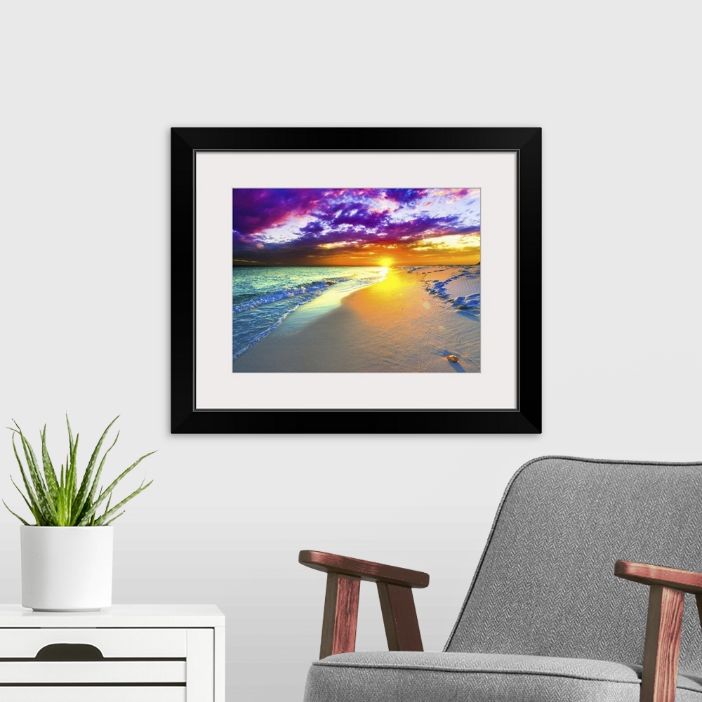 A modern room featuring A beautiful purple and blue sunset over a sandy beach shoreline. The ocean takes up a small part ...