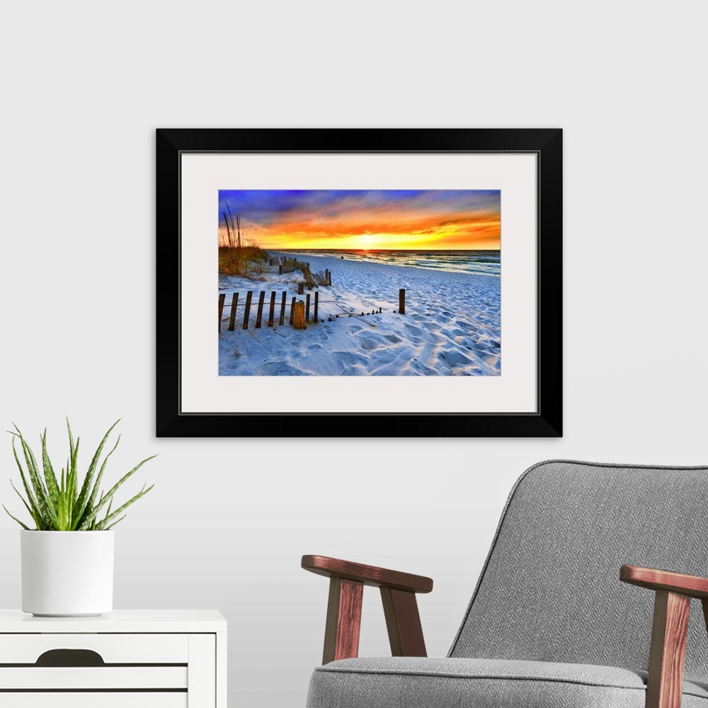 A modern room featuring A dark burning red sunset on the beach in this beautiful landscape. A burning sun sets in the dis...