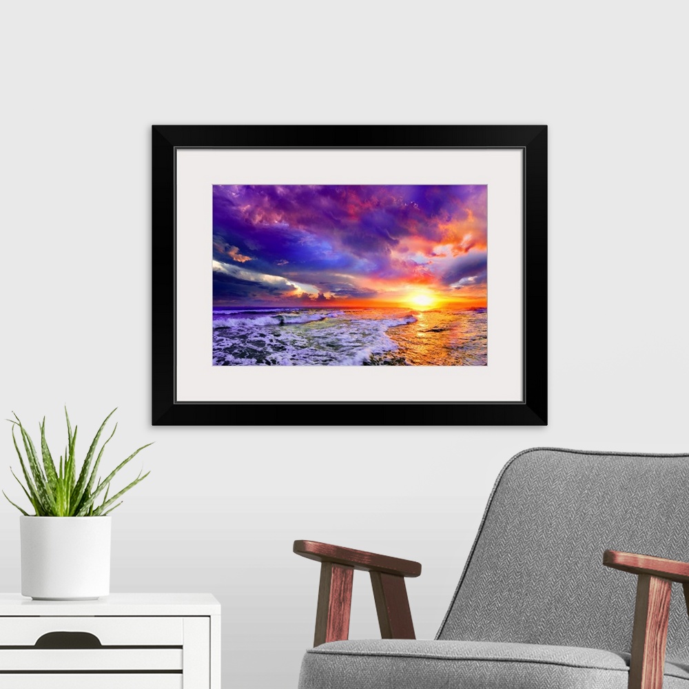 A modern room featuring A pink and purple abstract cloudscape and seascape at sunset.