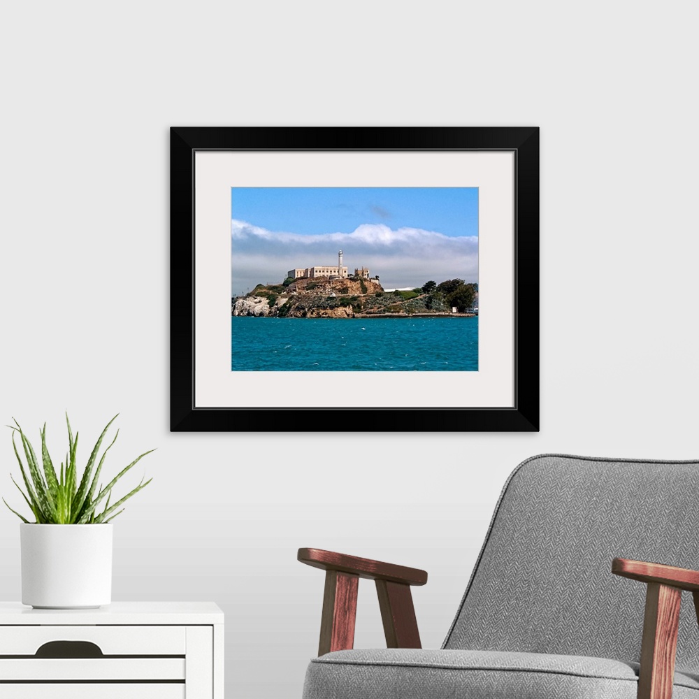 A modern room featuring The iconic Alcatraz Island looms as we view from the water.