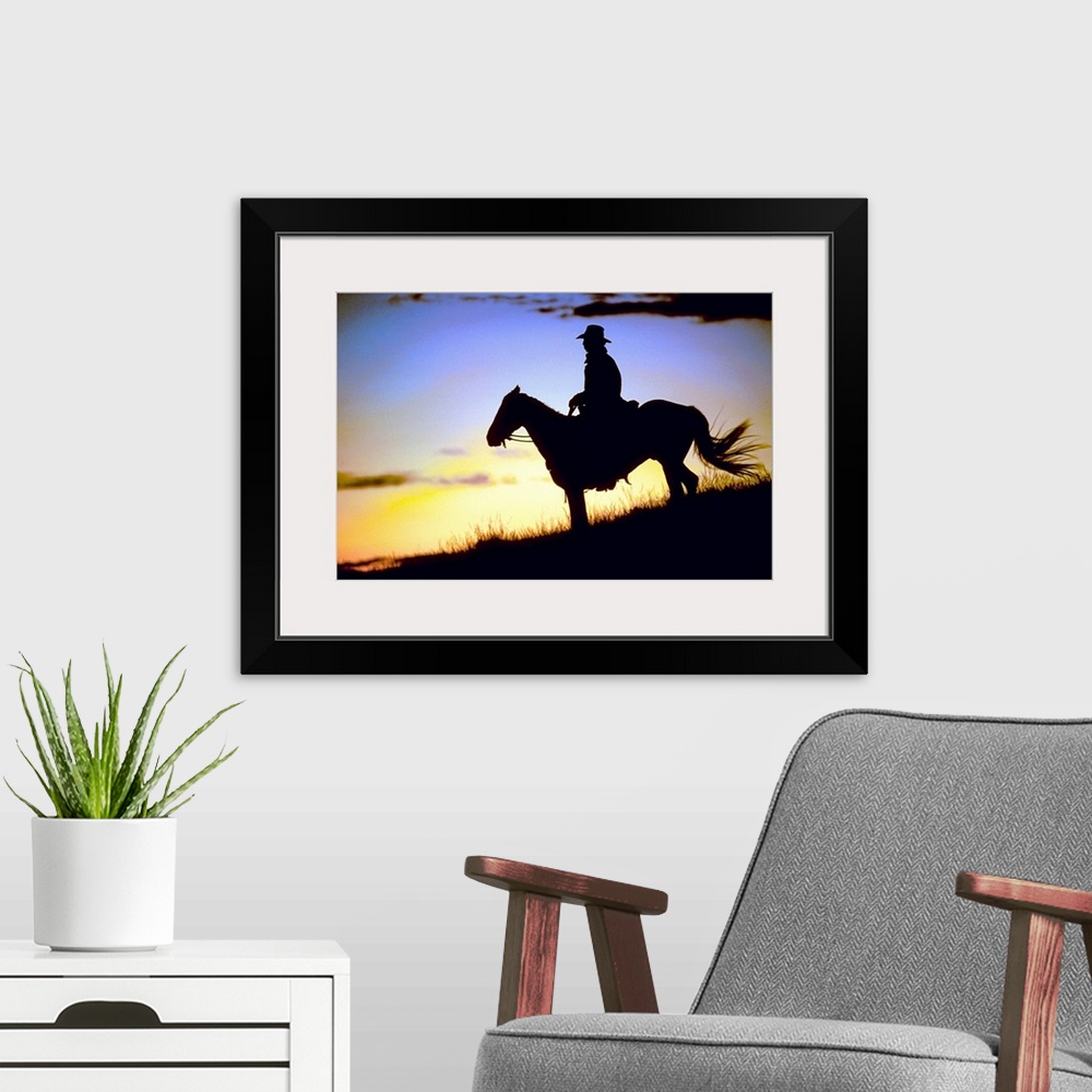 A modern room featuring A lone figure and his steed on a hillside was the light fades around them in this landscape photo...