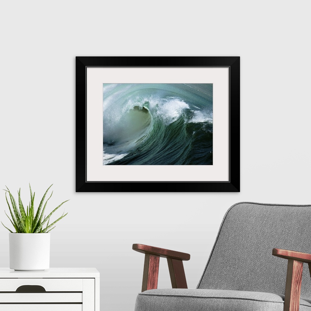 A modern room featuring Curl of big wave off of coast of California.