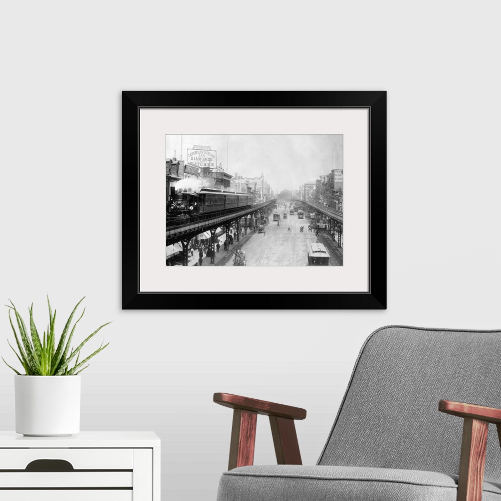 A modern room featuring Elevated trains roll over busy streets in Manhattan's Bowery neighborhood.