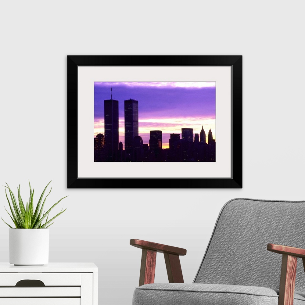 A modern room featuring New York City at dusk