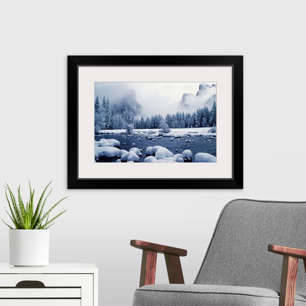 A modern room featuring Snow covered mountain peaks and trees, Merced River, Yosemite National Park, Mariposa County, Cal...