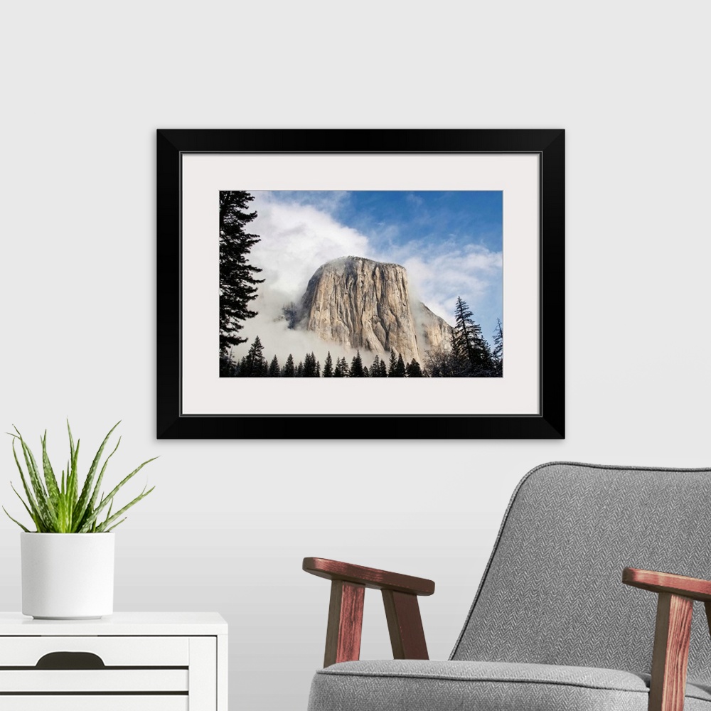 A modern room featuring Yosemite in November El Capitan coming out of fog.