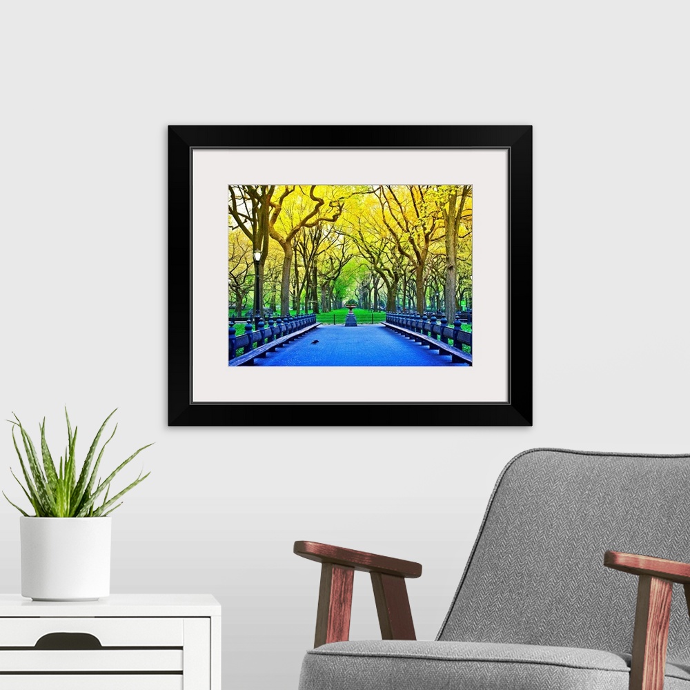 A modern room featuring Vividly colored photograph of a bridge surrounded by trees in Central Park.