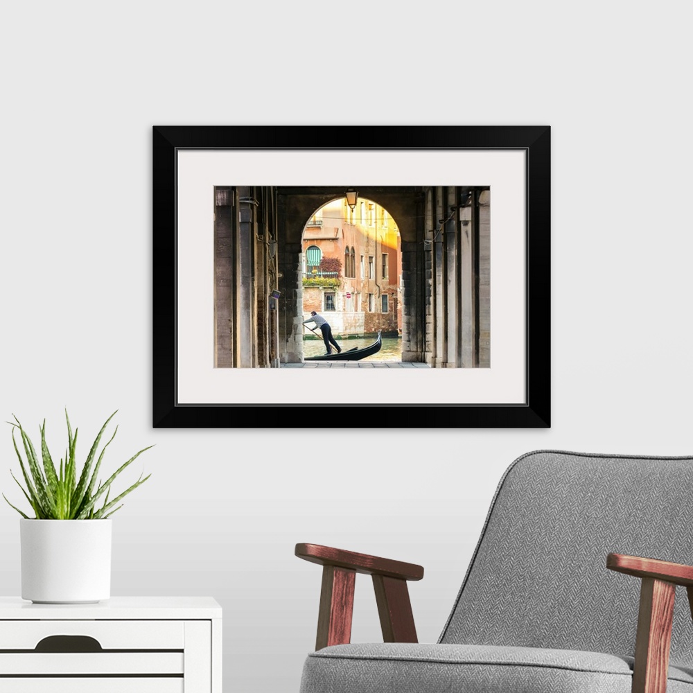 A modern room featuring Italy, Veneto, Venice. Gondola passing on Grand canal seen from a colonnade