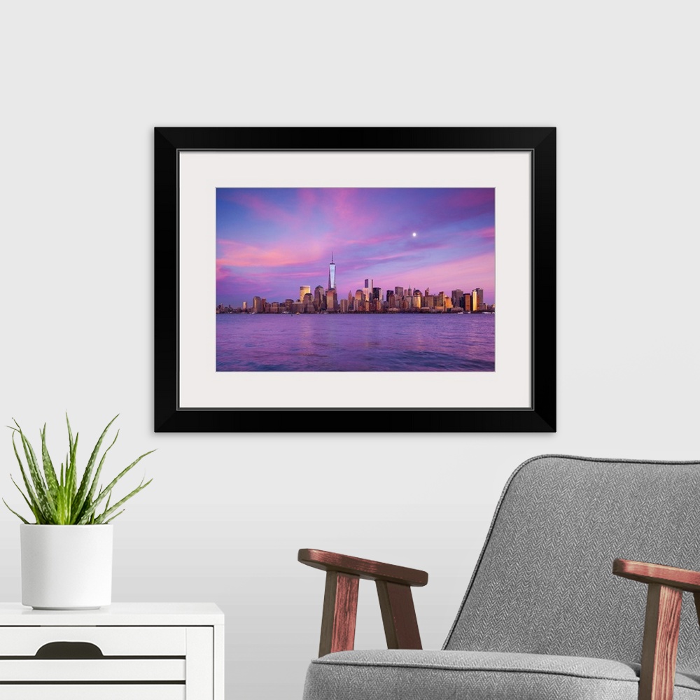 A modern room featuring USA, New York, New York City, lower Manhattan and Freedom Tower, dusk