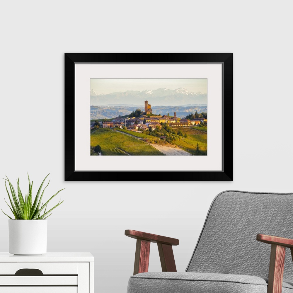 A modern room featuring The vineyards of Serralunga d'Alba and Alps in background during autumn sunrise, Serralunga d'Alb...