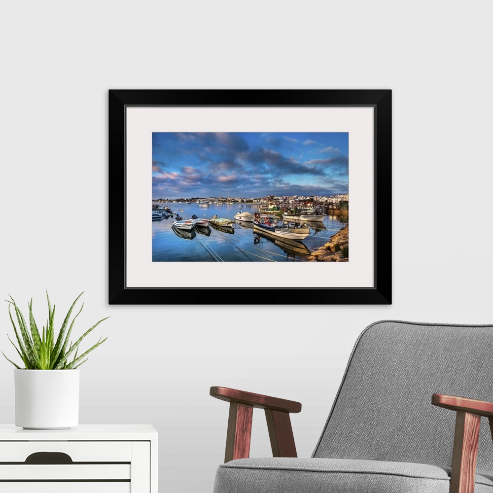 A modern room featuring View from fishing harbour towards old town, Lagos, Algarve, Portugal