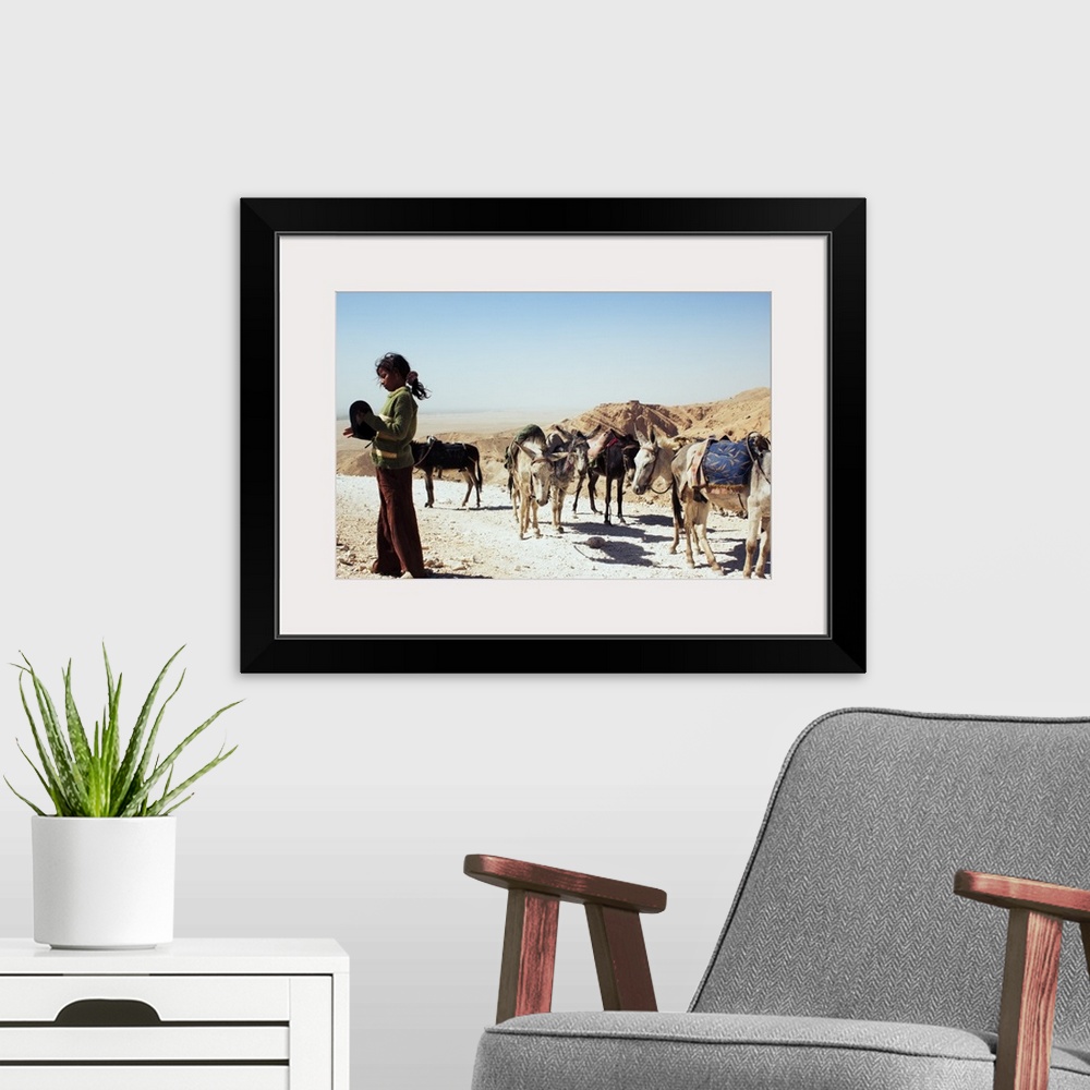 A modern room featuring A Young Girl With Her Caravan of Donkeys