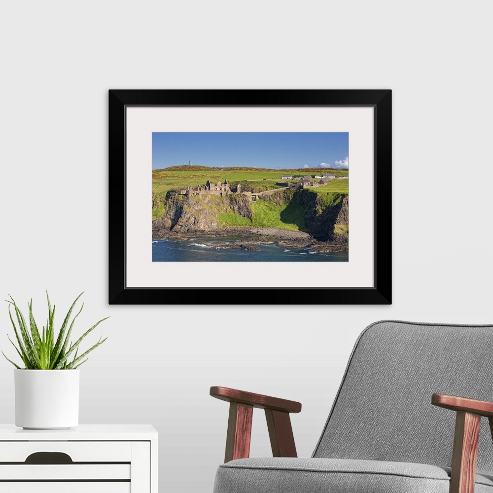 A modern room featuring Dunluce Castle, Bushmills, Northern Ireland, UK - Aerial Photograph