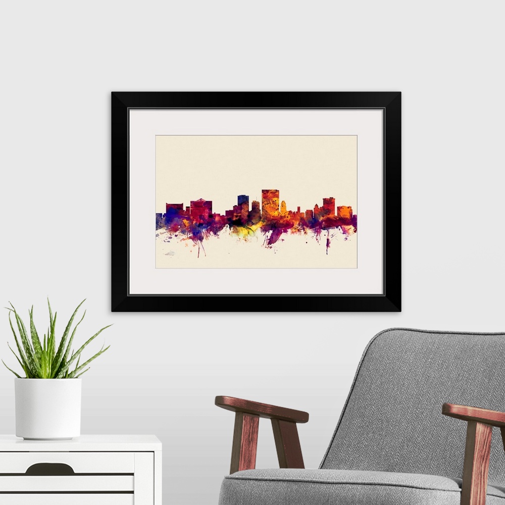 A modern room featuring Contemporary artwork of the El Paso city skyline in watercolor paint splashes.