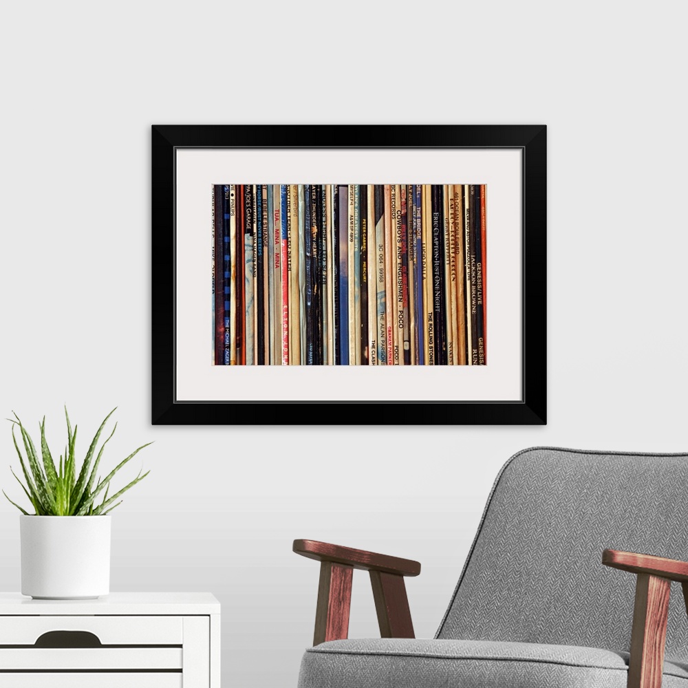 A modern room featuring Big photograph shows a large collection of LP vinyl records that includes works from artists such...