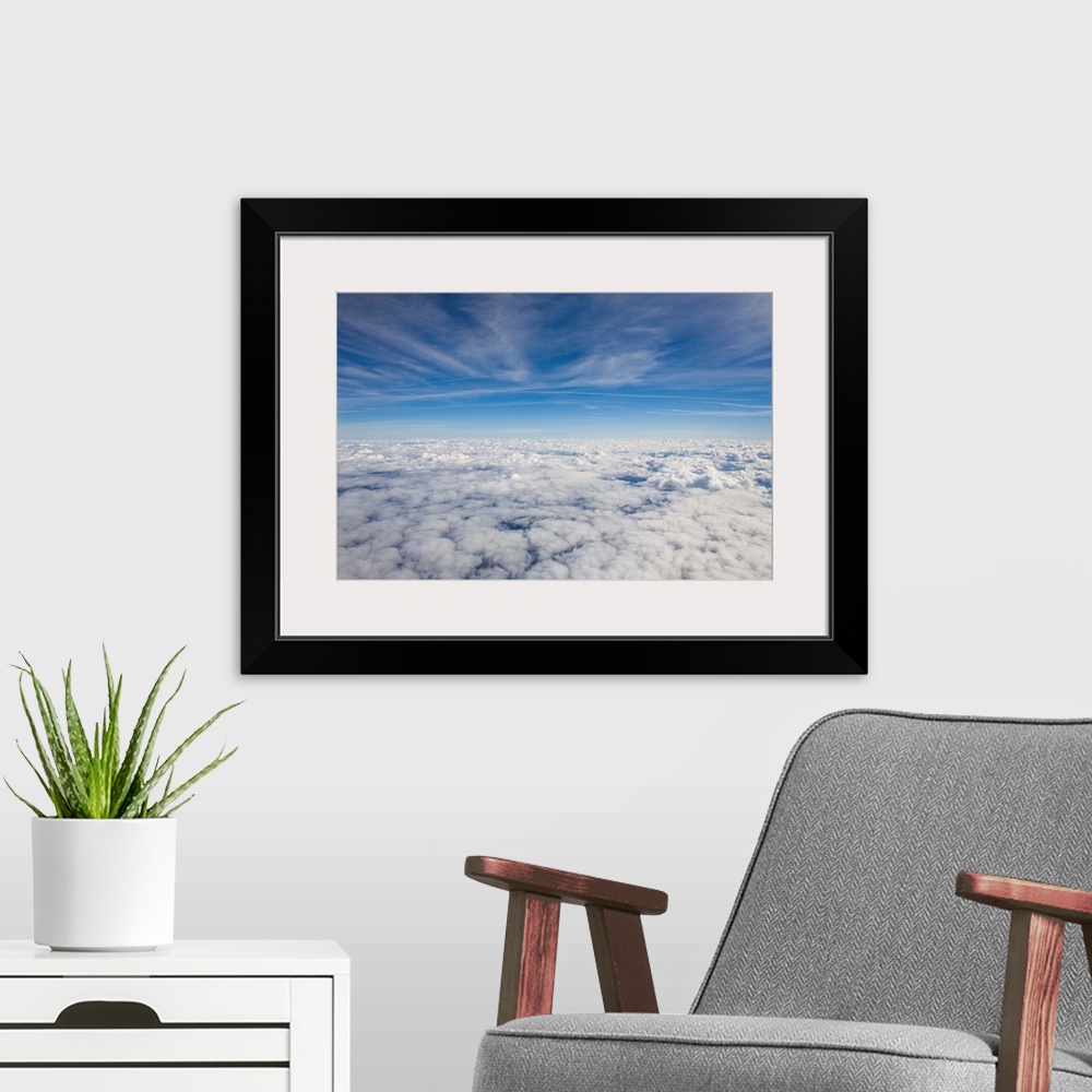 A modern room featuring Just above the clouds, the sky split into blue and white layers.
