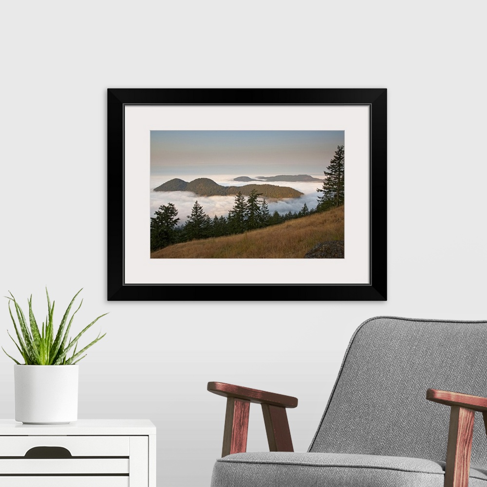 A modern room featuring Entrance Mountain and Mount Woolard emerge from sea fog around Orcas Island as seen from Mt. Cons...