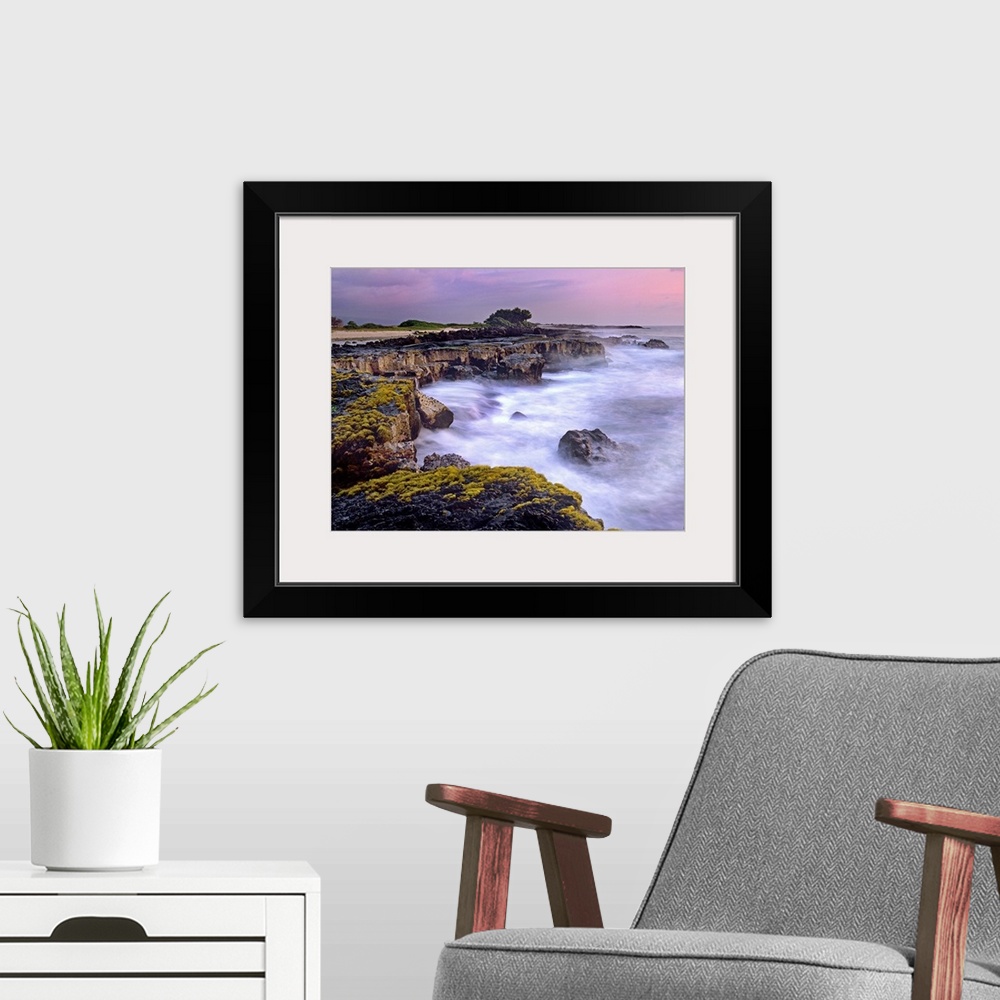 A modern room featuring Photograph of rocky cliff line that drops into the ocean under a cloudy sky.