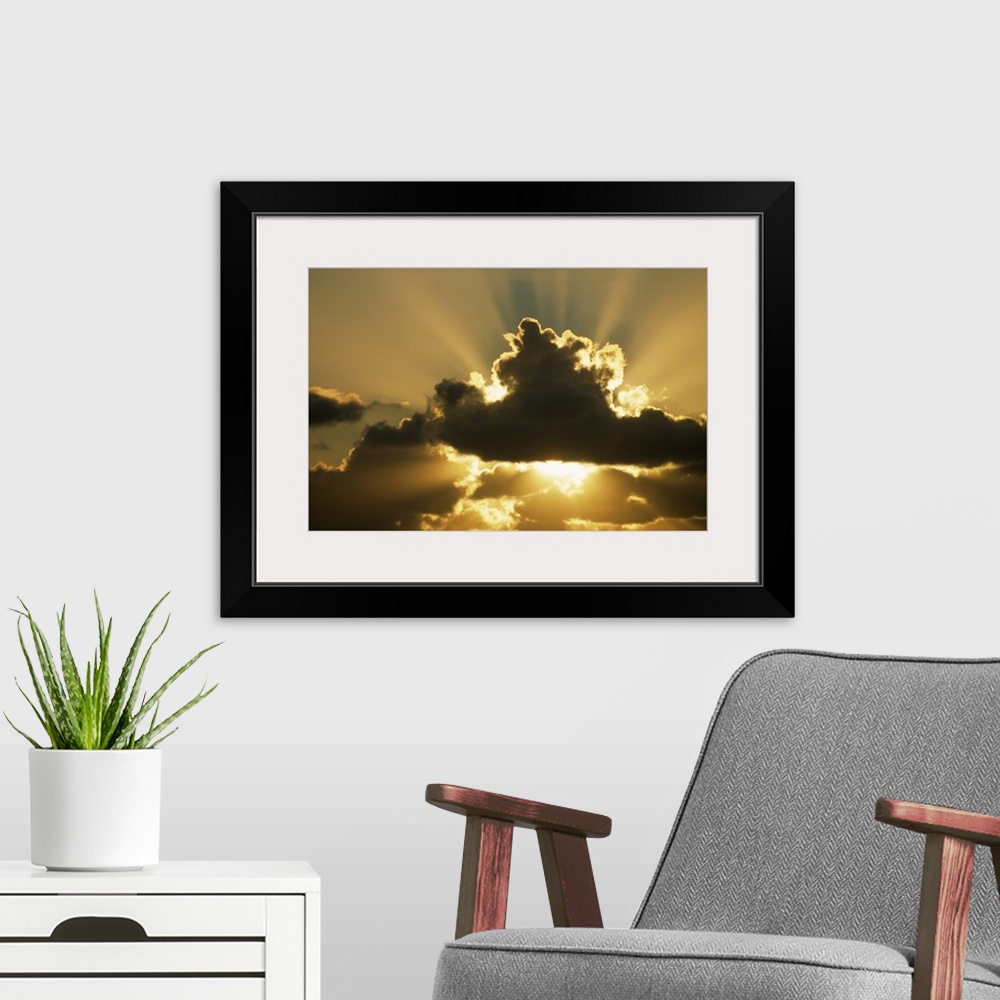 A modern room featuring SUN RAYS BEAM FROM BEHIND CUMULUS CLOUDS,