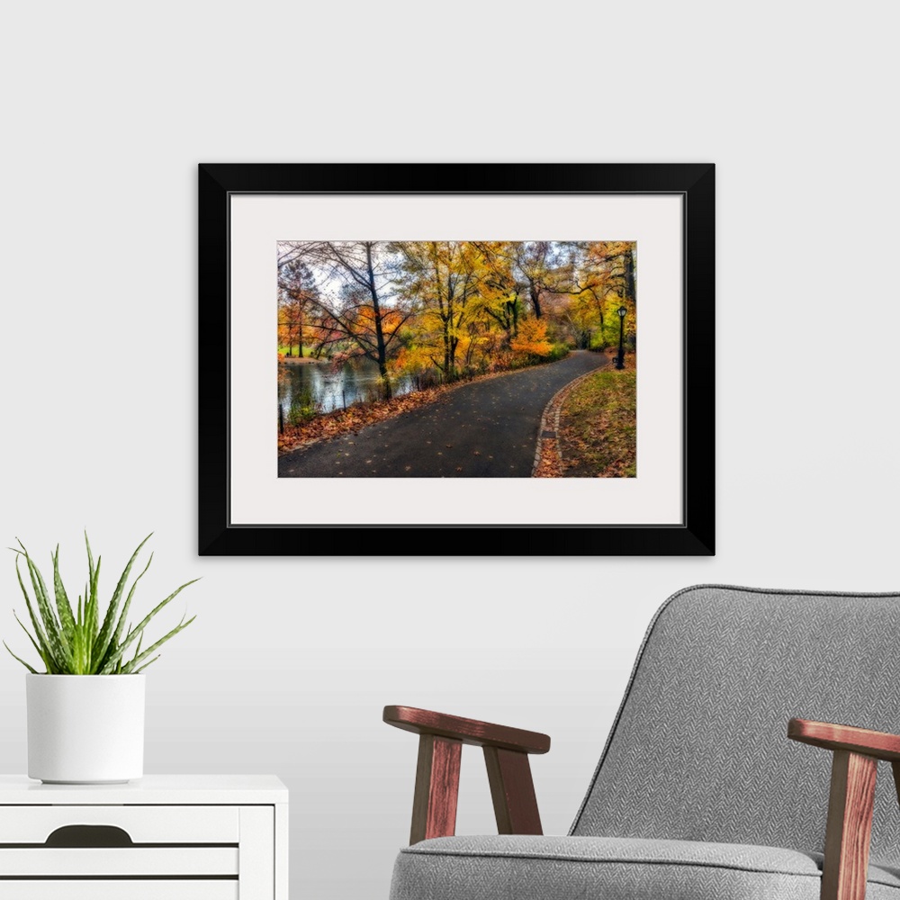 A modern room featuring Soft-focus effect applied to fall foliage around a pathway in the northern section of Central Park.