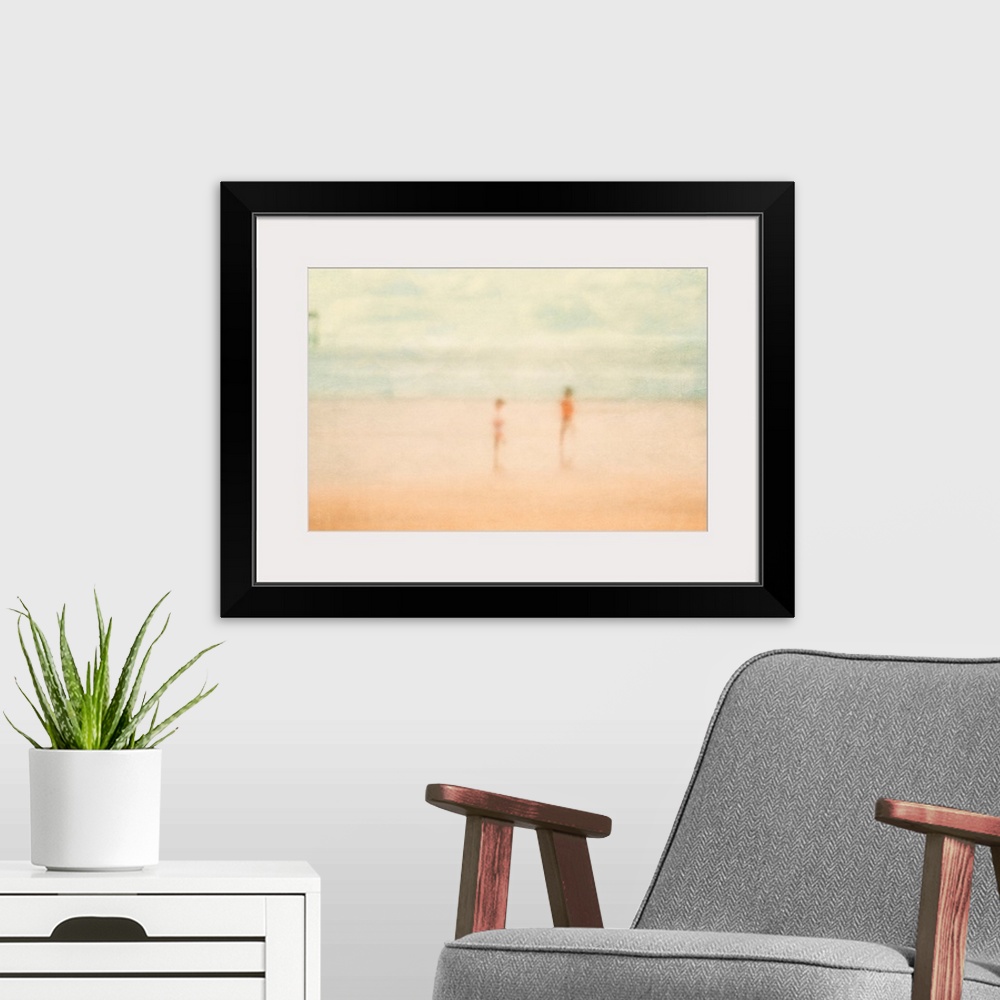 A modern room featuring Soft focus painting of two children standing on the beach with ocean and pier in distance.