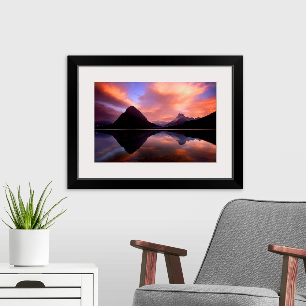 A modern room featuring Stunning photo of the sunset over the mountains and water at Glacier National Park in Montana.
