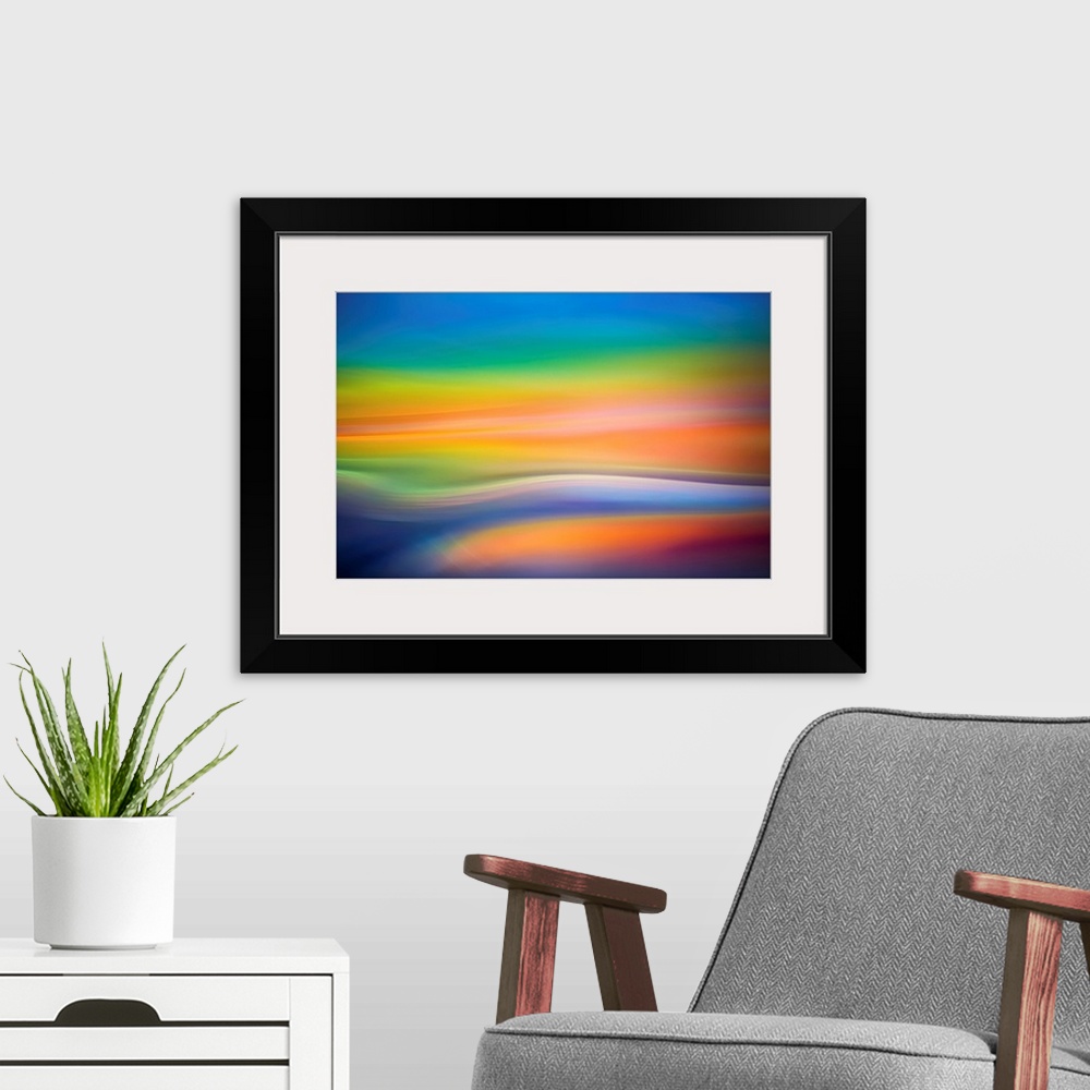 A modern room featuring Abstract art with colorful soft focused waves of color running horizontally across the canvas in ...