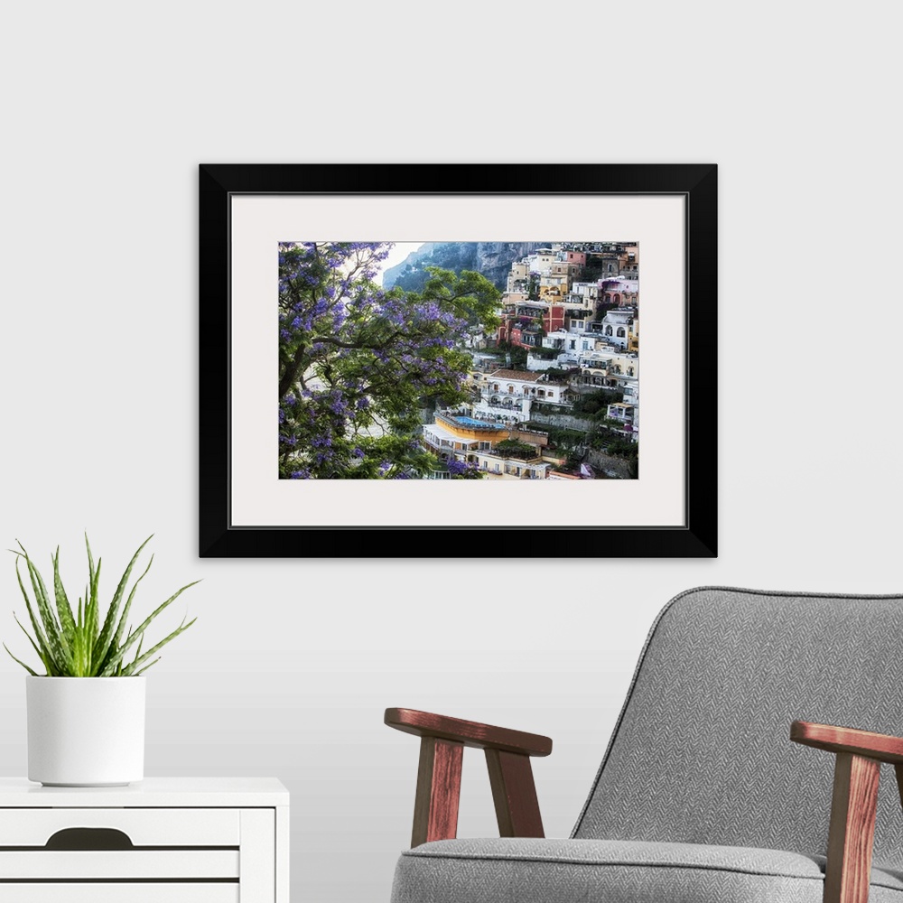A modern room featuring High Angle View of Hillside Houses in Positano with a Blooming Jacaranda