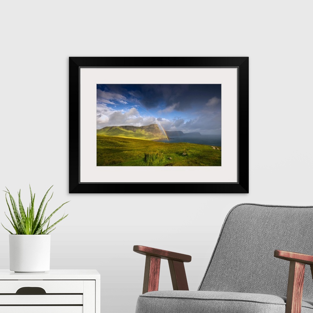 A modern room featuring Fine art photo of lush green cliffs at the edge of the sea under a dramatic sky.
