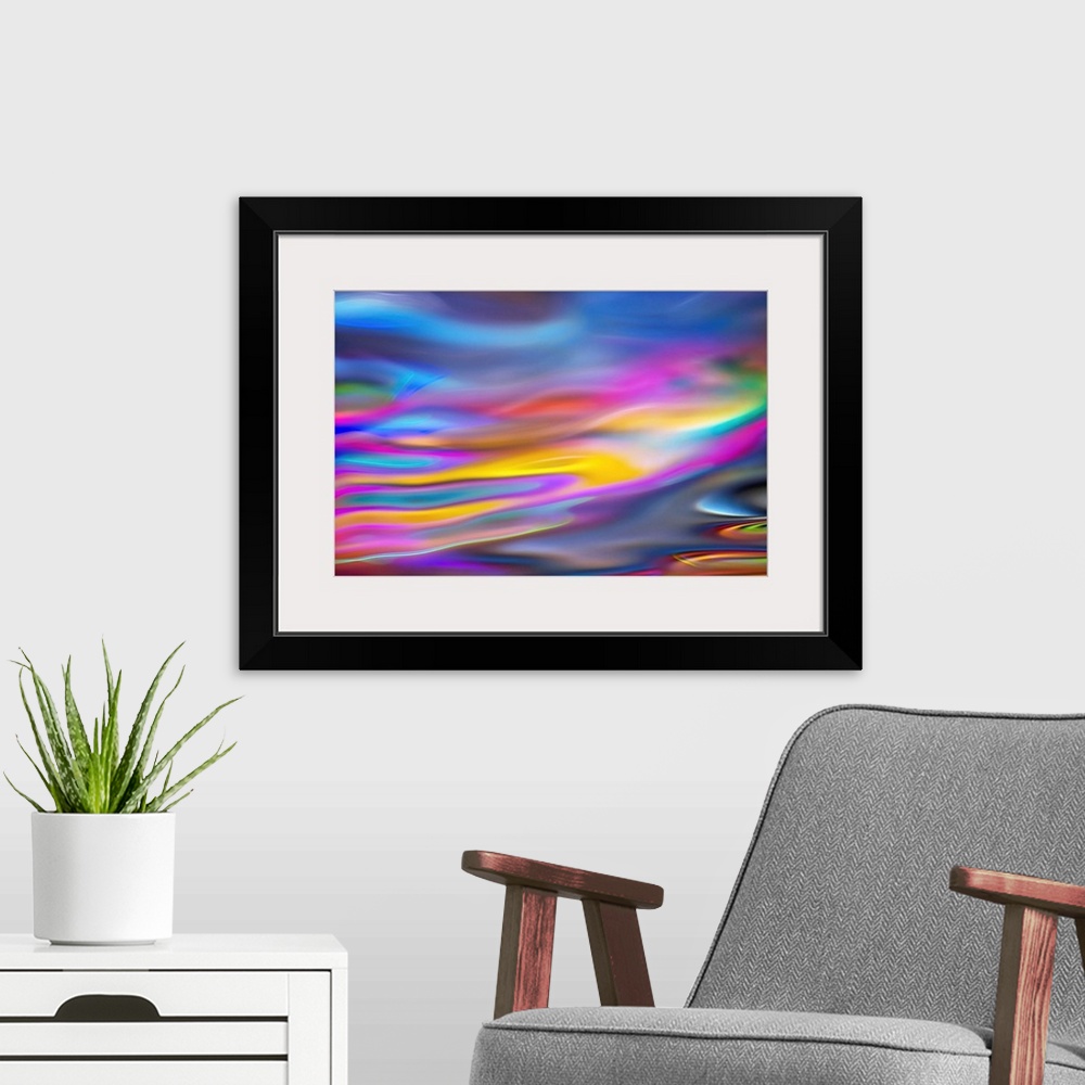 A modern room featuring Abstract art with colorful waves of color running horizontally across the canvas in a dreamlike way.