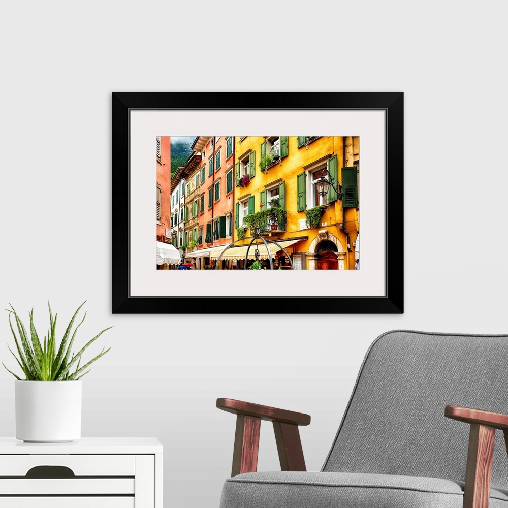A modern room featuring Fine art photo of the brightly colored buildings and window shutters of an Italian street.