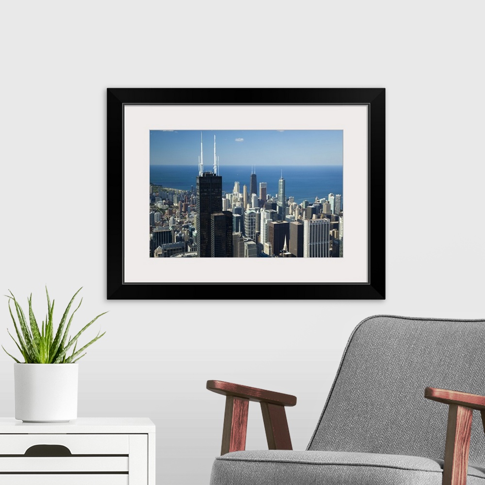 A modern room featuring This is an urban landscape showing a view of the city and lake from above on a clear and sunny day.