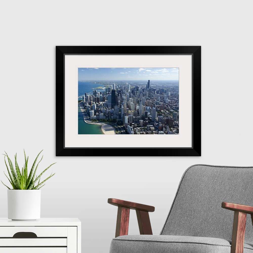 A modern room featuring Giant, landscape, aerial photograph along the Lake Michigan shoreline of Chicago, Illinois.