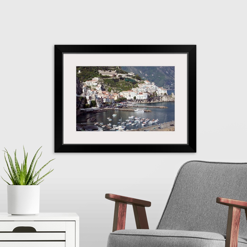 A modern room featuring Photograph of busy port town with boats coming in to dock.  Part of the water's edge is made of m...