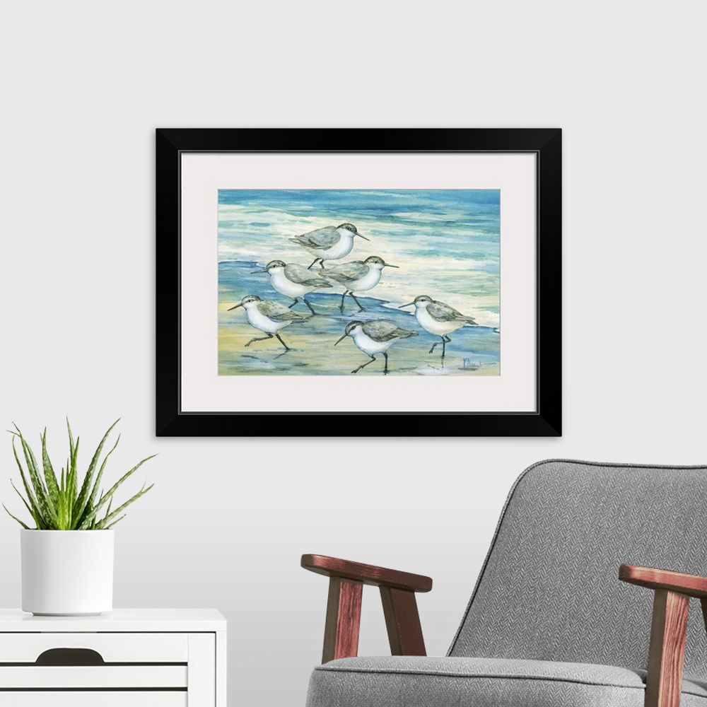 A modern room featuring Contemporary artwork of a flock of sandpiper birds on the beach.