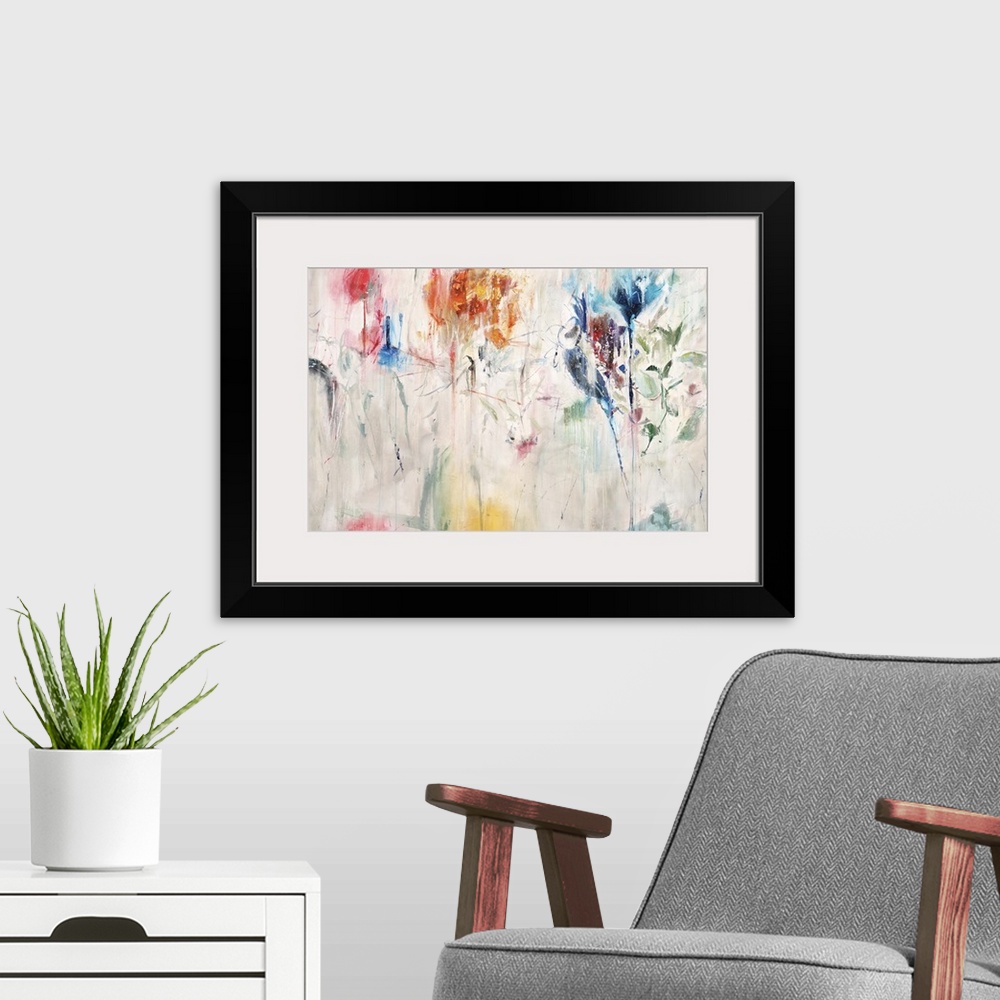 A modern room featuring Contemporary abstract painting of a colorful flowers against a neutral background.
