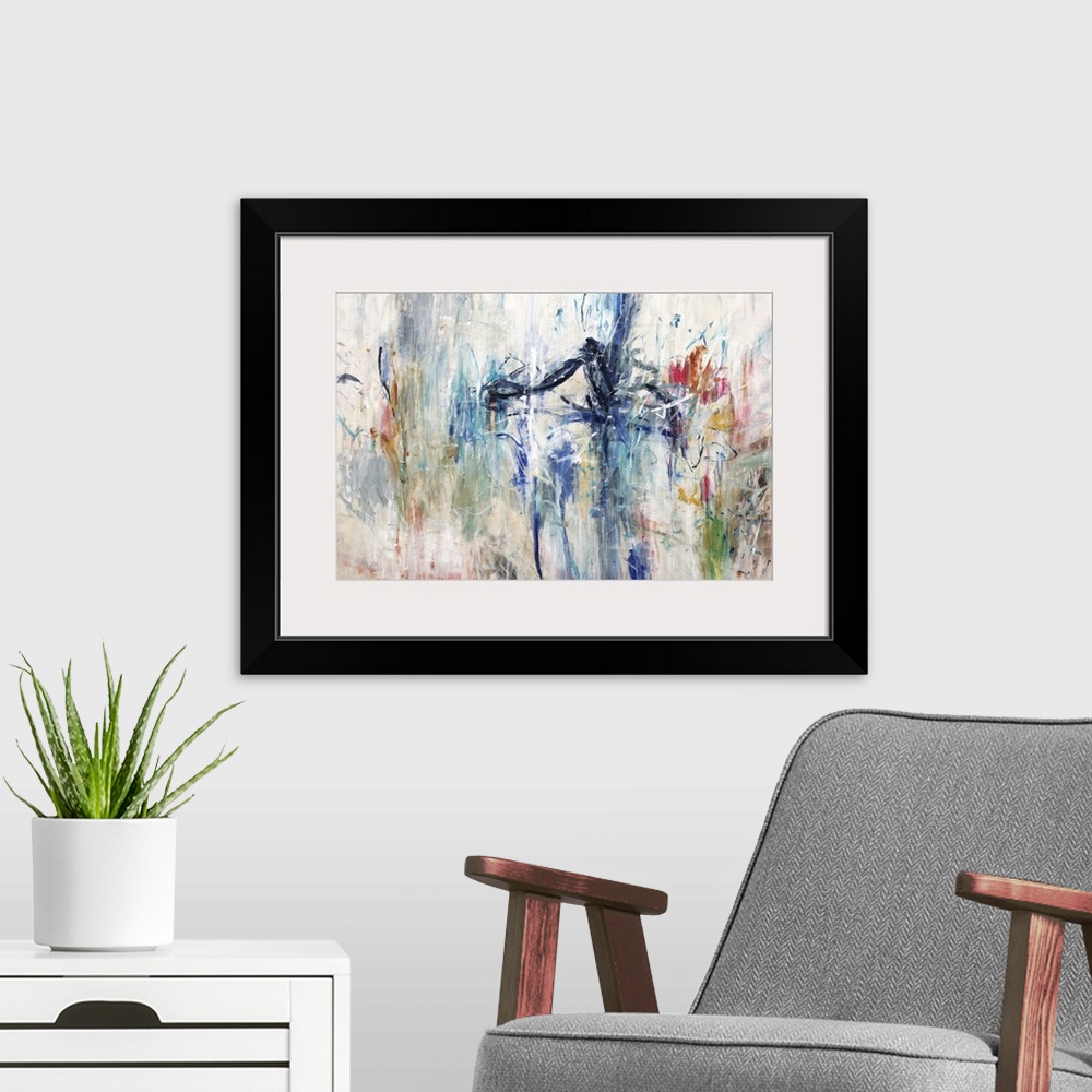 A modern room featuring Large abstract painting with all of the colors of the rainbow on a cream background.