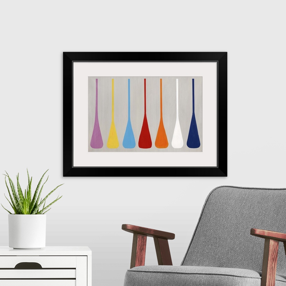 A modern room featuring Modern art of a row of similar multicolored shapes that resemble boat paddles, on a light, neutra...